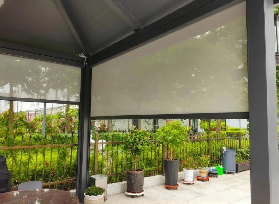 Grey perimeter screen blinds beneath a framed patio roof, forming screened bays around plants.