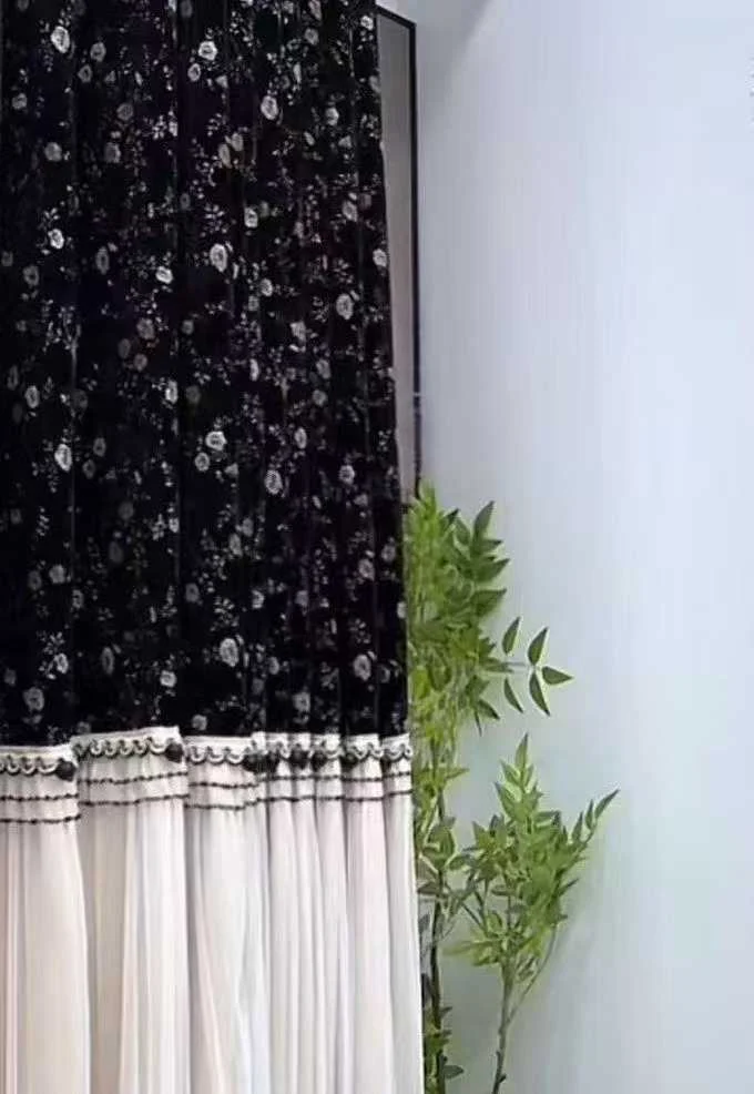 Black upper fabric with tiny pale floral motif joined horizontally to ivory gathered sheer below — supplied curtain design reference.