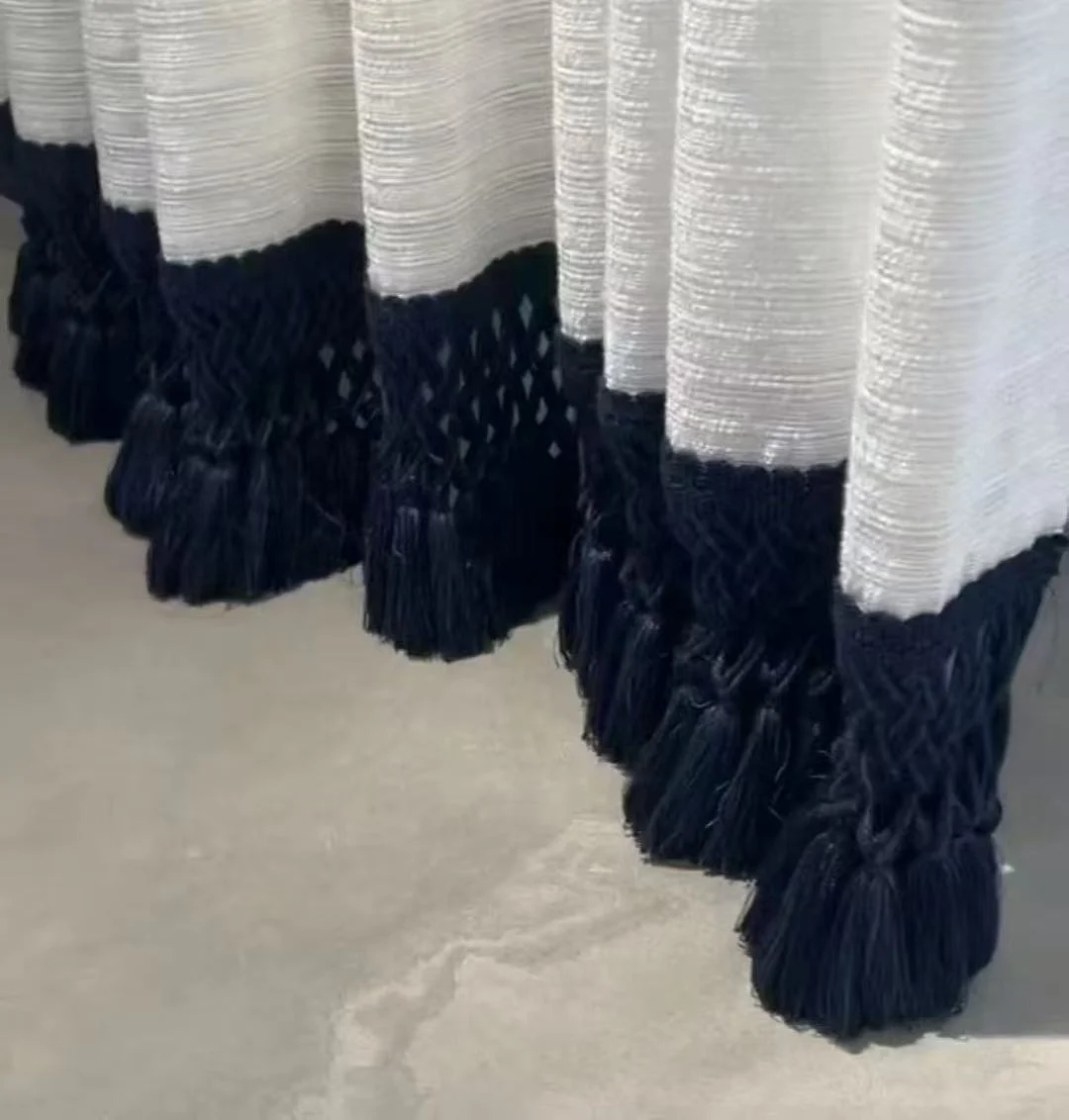 Navy knotted fringe & textured ivory hem — close-up of the supplied curtain photograph.