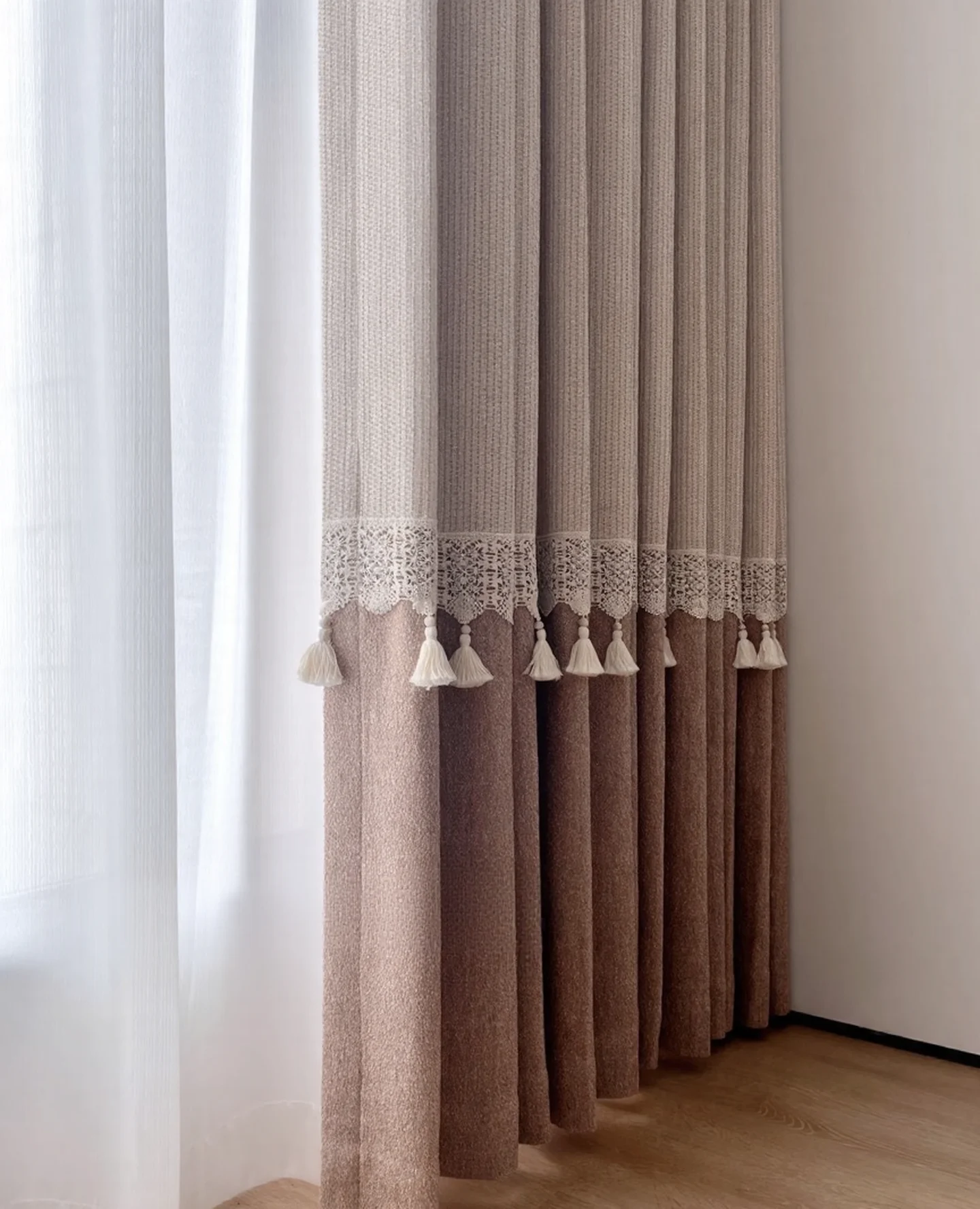 Scalloped lace, tassels & the rose-panel seam — close-up of the supplied curtain photograph.