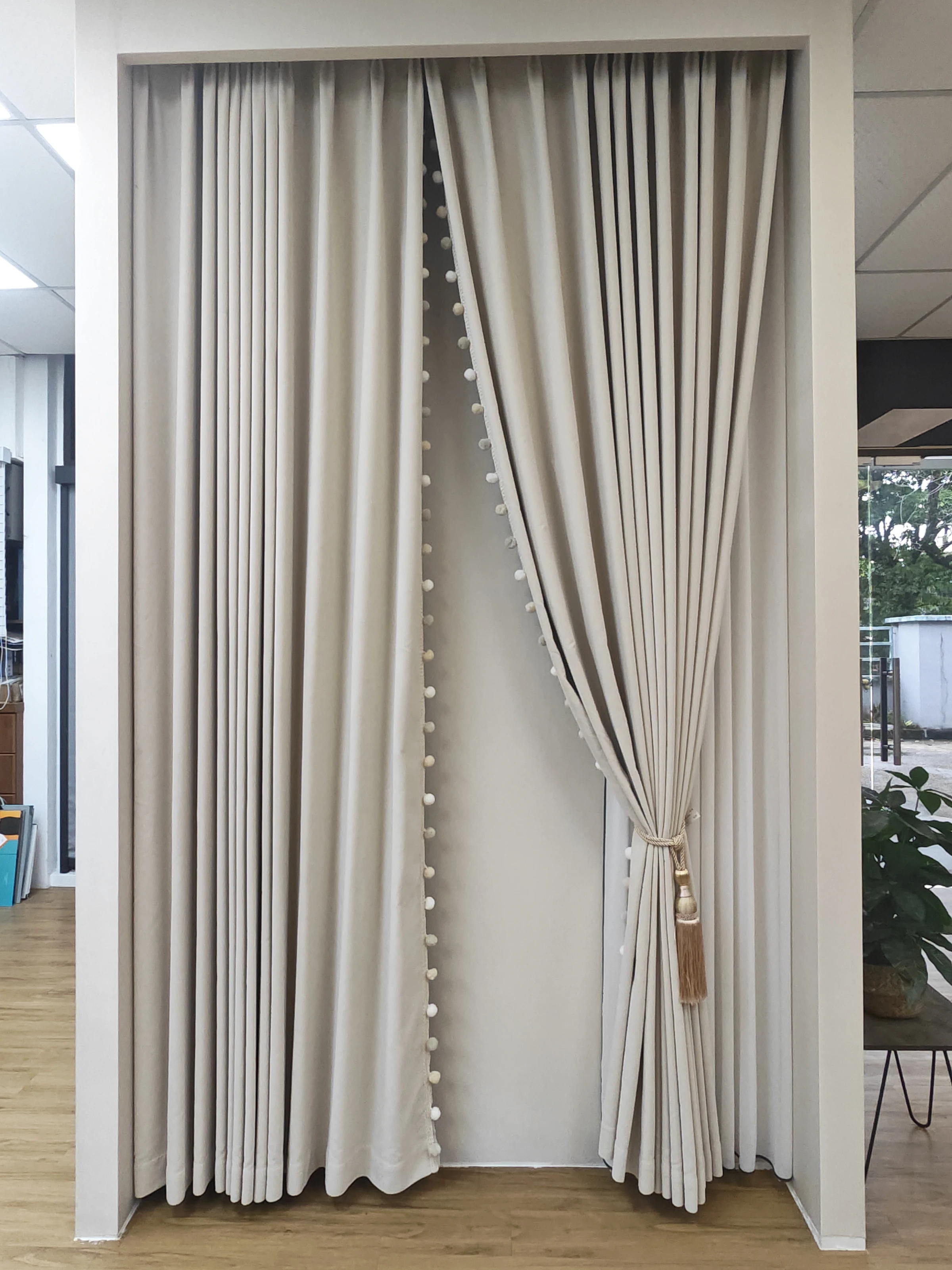 Fine piping, ivory folds & tassel tieback — close-up of the supplied curtain photograph.